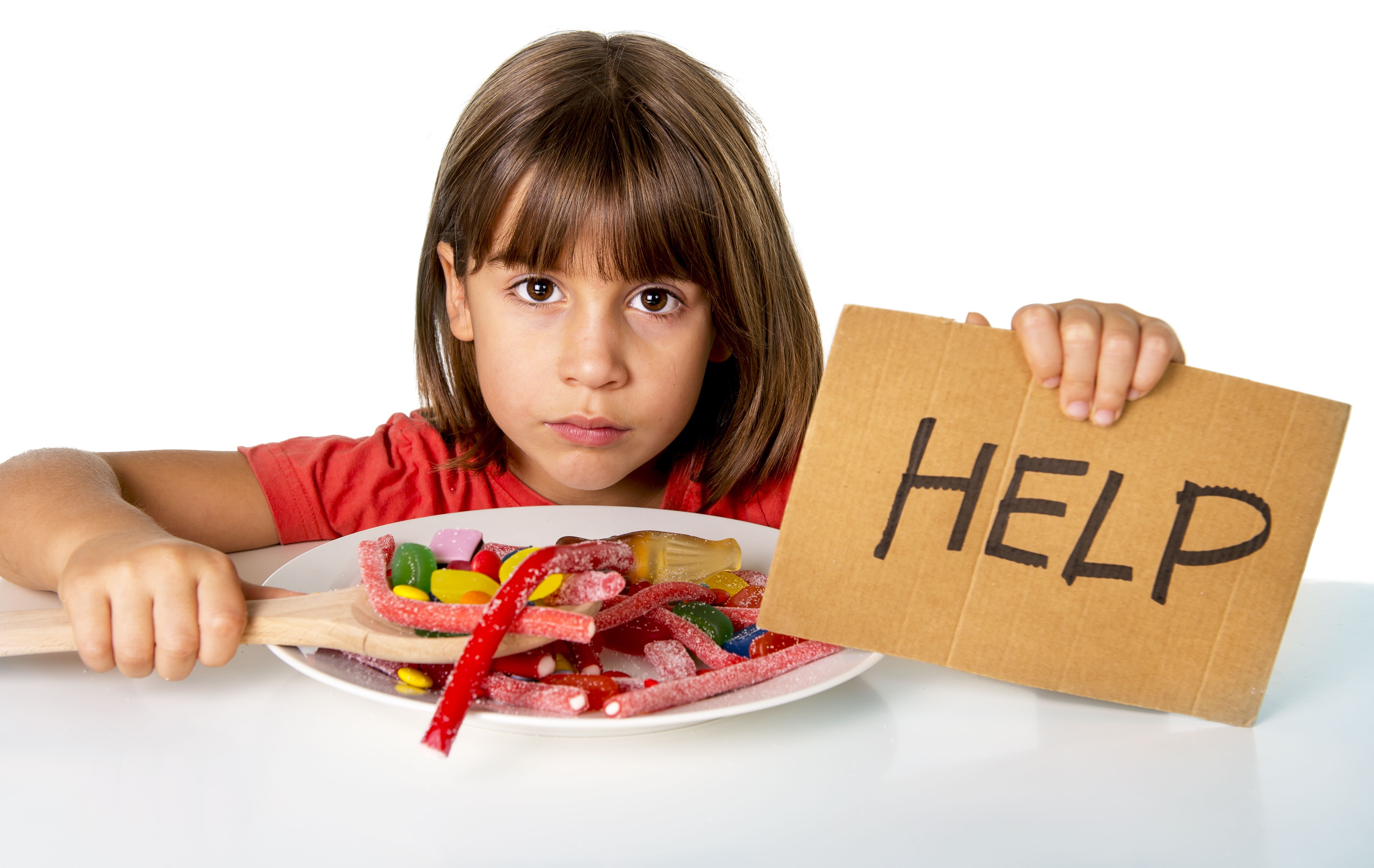 little child eating sweet sugar in candy dish holding sugar spoo